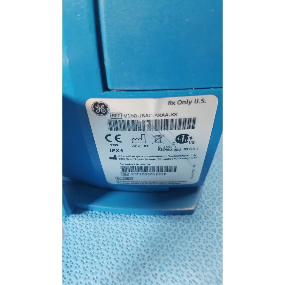 Blue ge healthcare v180-jbac-axaa-xx vital signs monitor with white label showing model and certification information