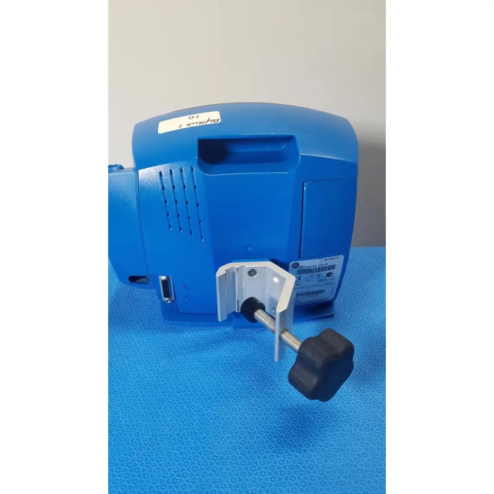 Blue GE Healthcare V180-JBAC-AXAA-XX vital signs monitor with white mounting bracket and black adjustment knob