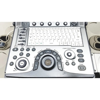 Silver-colored GE logiq e portable ultrasound machine console with built-in keyboard and multiple control buttons