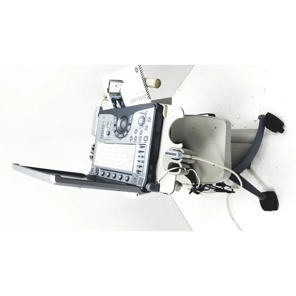Ge logiq e portable ultrasound machine with black and silver control panel on wheeled cart portable ultrasound device