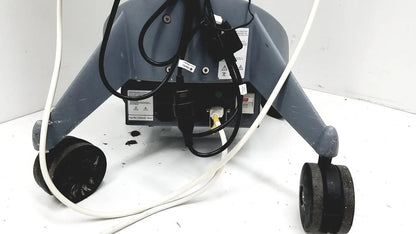 Gray industrial-grade floor cleaning machine with black wheels and cords shown with logiq e portable ultrasound machine untested
