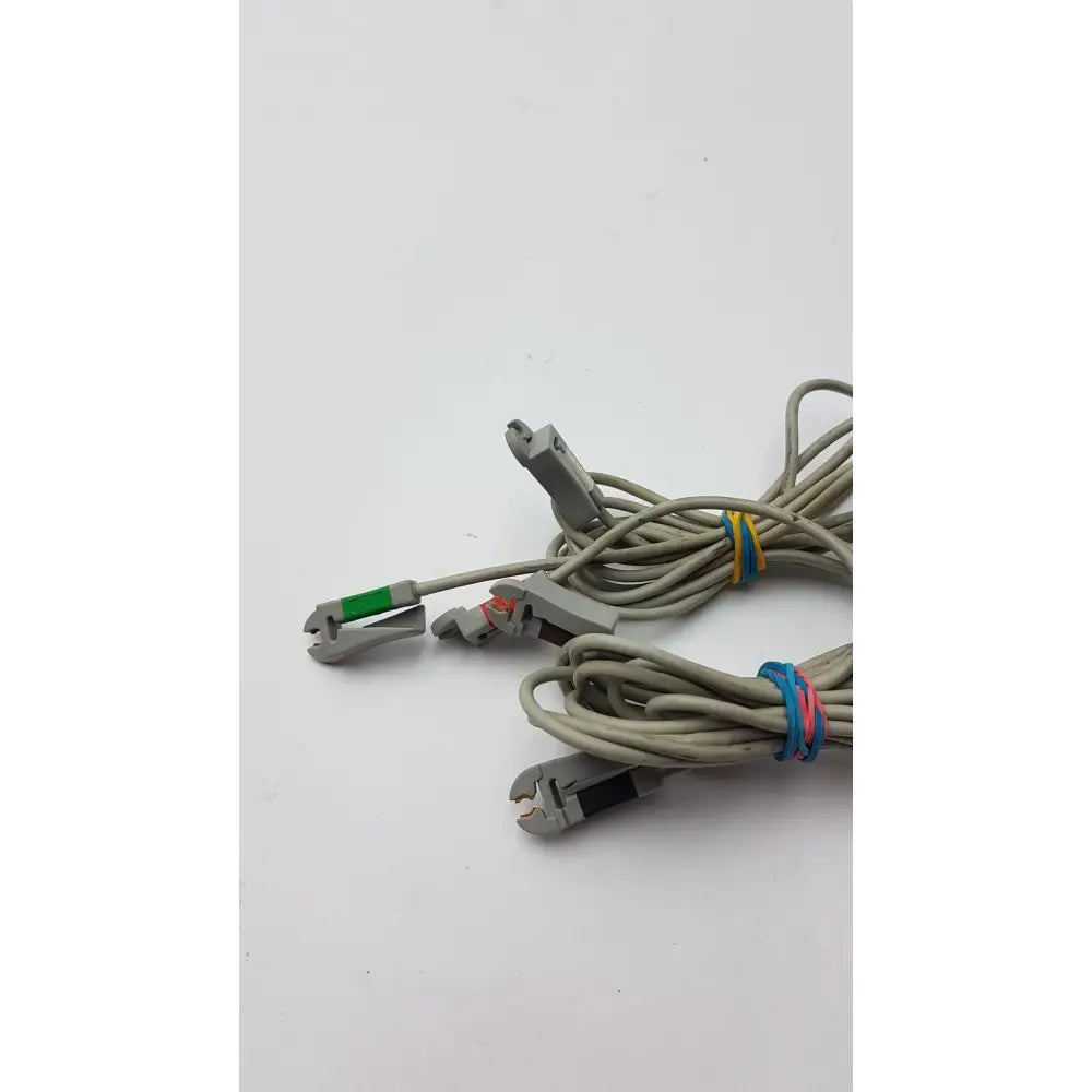 Gray coiled multilink esu patient cable with gray plastic connectors and colorful rubber bands for esu patient monitoring