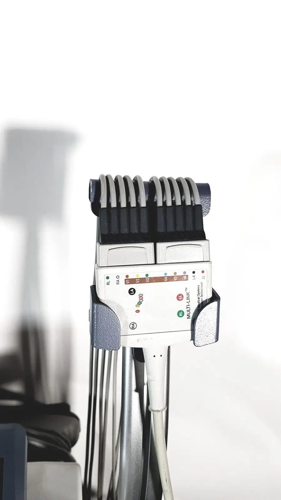 White medical mac1600 ecg device with black and gray components featuring multiple electrode leads in a row