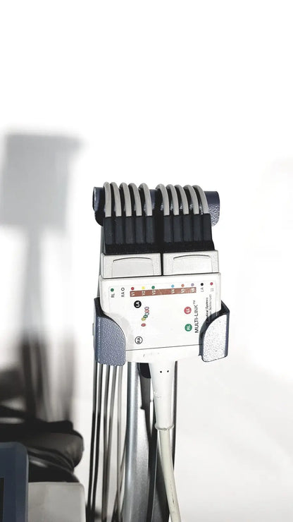 White medical mac1600 ecg device with black and gray components featuring multiple electrode leads in a row