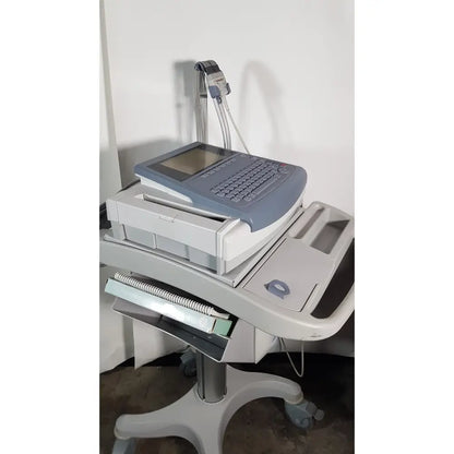 Gray medical mac1600 ecg analysis system with integrated keyboard touchscreen display mounted on wheeled cart