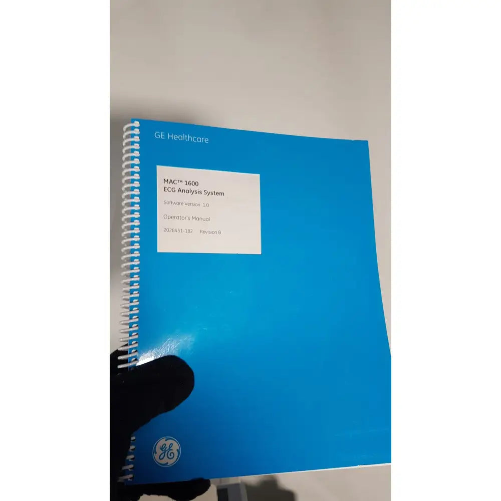 Blue spiral-bound operator’s manual for the medical mac1600 ecg analysis system with cart stand and extras