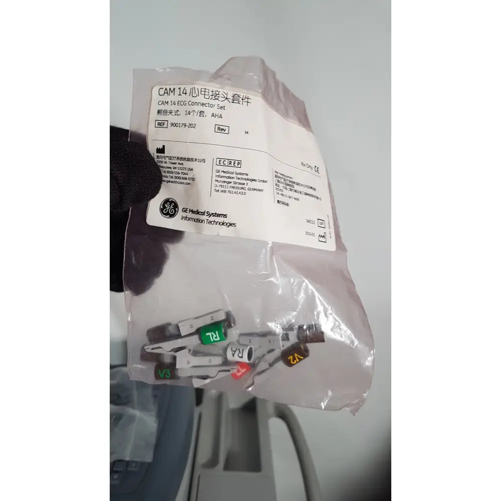 A set of white and gray medical mac1600 ecg connectors with colored labels in a clear plastic bag for heart monitoring