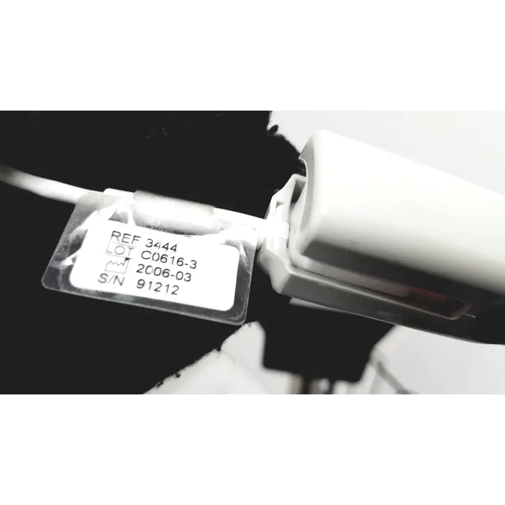 White plastic label with black text and clear cover on ge medical mini-torr plus patient monitor ref 3444 with rolling stand