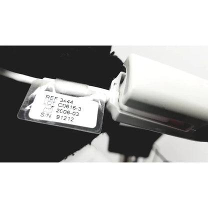 White plastic label with black text and clear cover on ge medical mini-torr plus patient monitor ref 3444 with rolling stand
