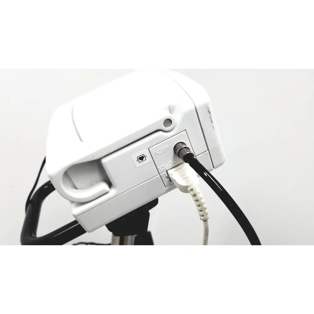 White plastic camera mount with black tripod base and connected cables on the back of ge medical plus patient monitor ref 3444
