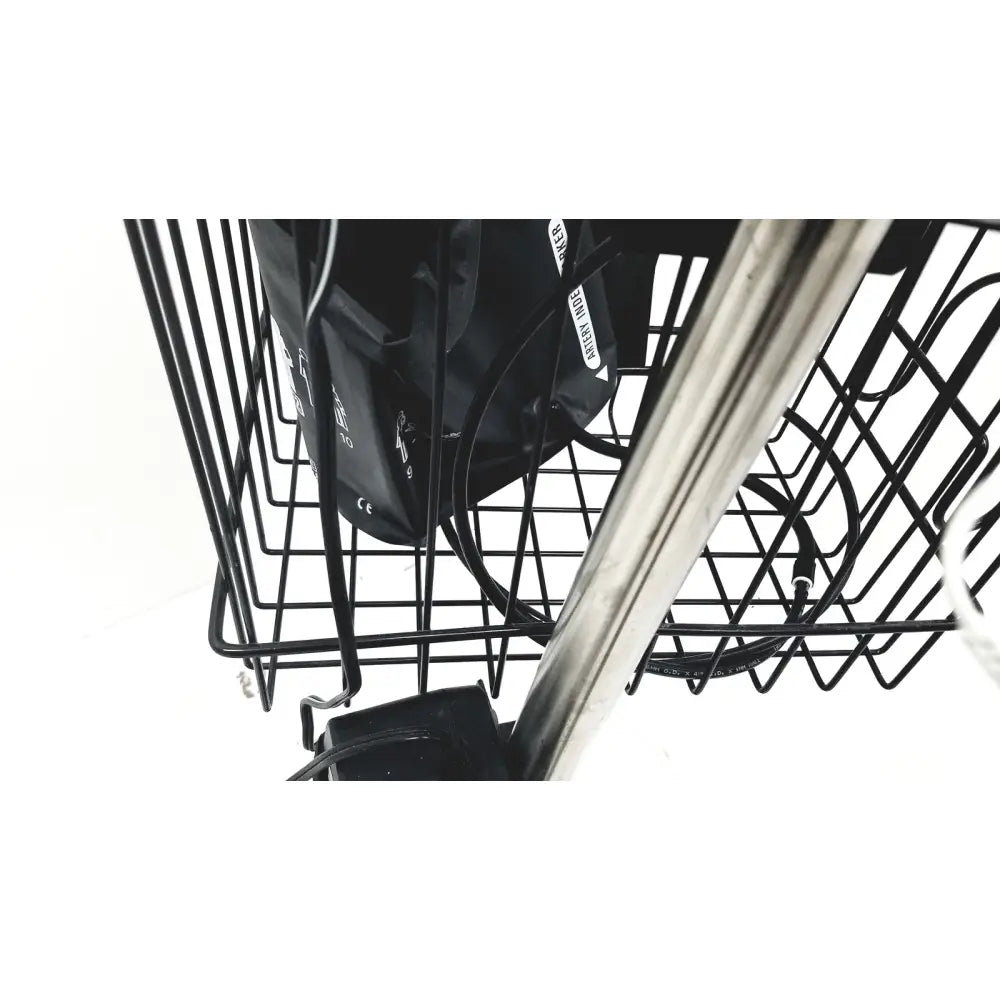 Black wire basket with metal frame holding black bag and coiled cables on ge medical mini-torr plus patient monitor ref cart