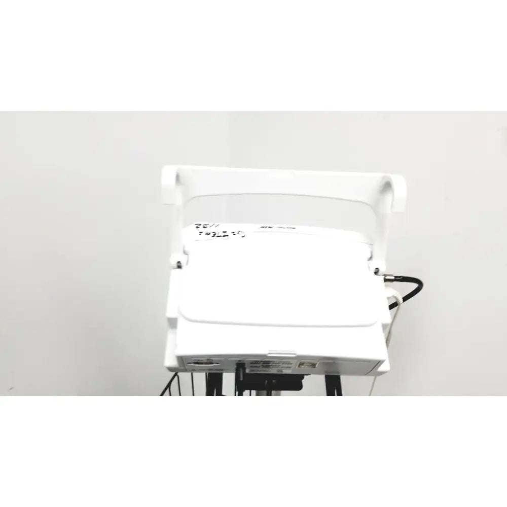 White plastic ge medical mini-torr plus patient monitor ref 3444 with curved handle and rolling stand cart