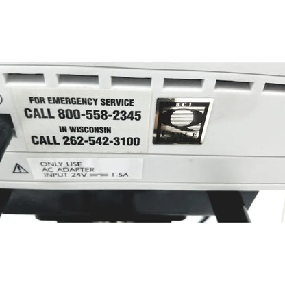 White plastic emergency service label with black text and silver bci lonn e logo on ge medical mini torr plus patient monitor ref 3444 with rolling stand
