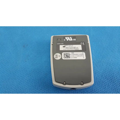 Back side of gray and white matte finish ge medical system cam hd 900995-003 ecg acquisition module with certification labels and qr code