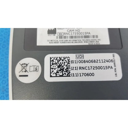 Gray plastic GE Medical System CAM HD 900995-003 ECG acquisition module with white labeling and QR code on the back side