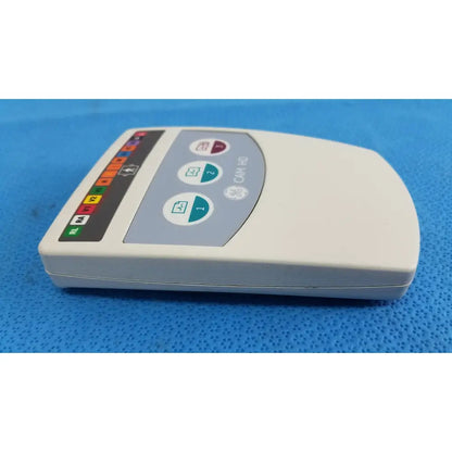 Cream-colored ge medical system cam hd 900995-003 ecg acquisition module with gray panel and colored indicator lights for reuse medical use