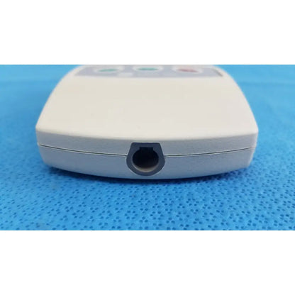 White plastic ge medical system cam hd 900995-003 ecg acquisition module with circular port and three colored buttons