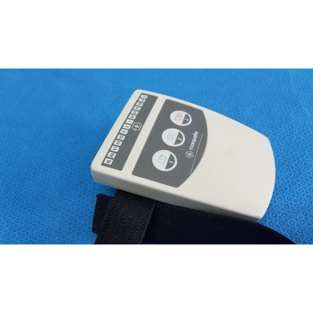 White rectangular ge marquette cam-14 acquisition module with black buttons and strap for medical use