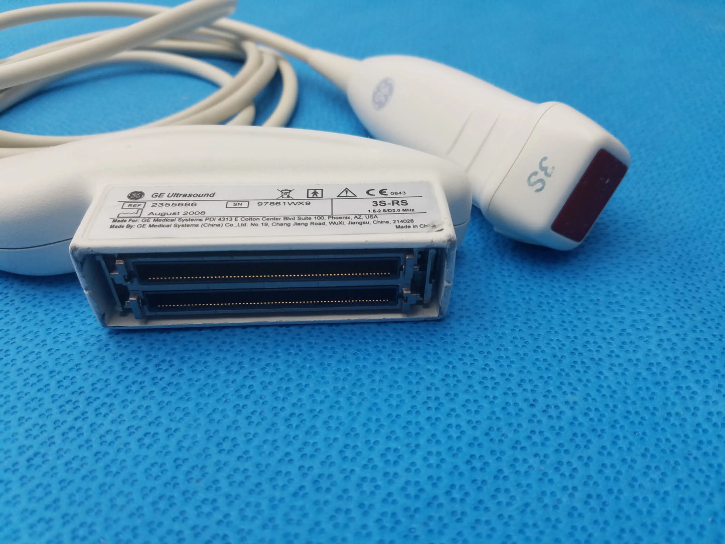 White GE Medical Systems 3S-RS ultrasound transducer probe with red-tipped probe and rectangular connector housing for ultrasound imaging
