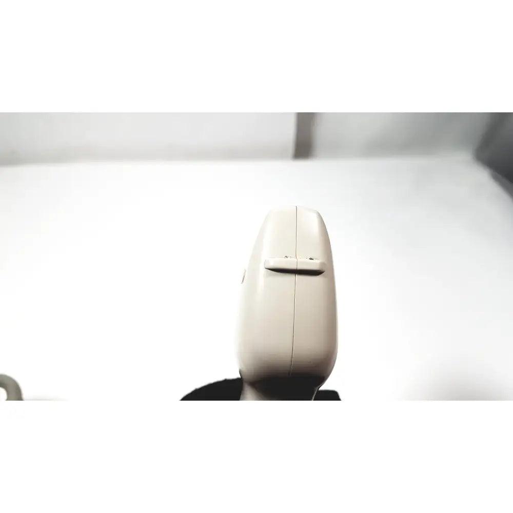 Beige plastic handheld ge medical systems ultrasound convex array transducer with central button and vertical seam
