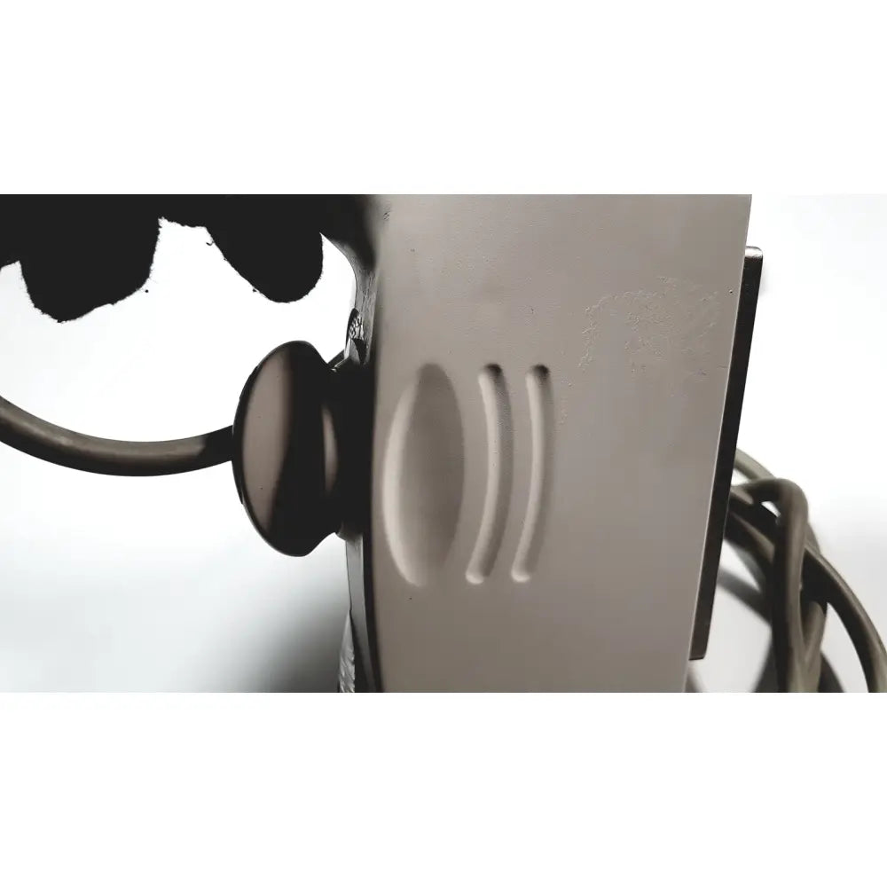 Silver-colored metal hair dryer with matte finish and three vertical ventilation slots shown with ge medical systems ultrasound convex array transducer