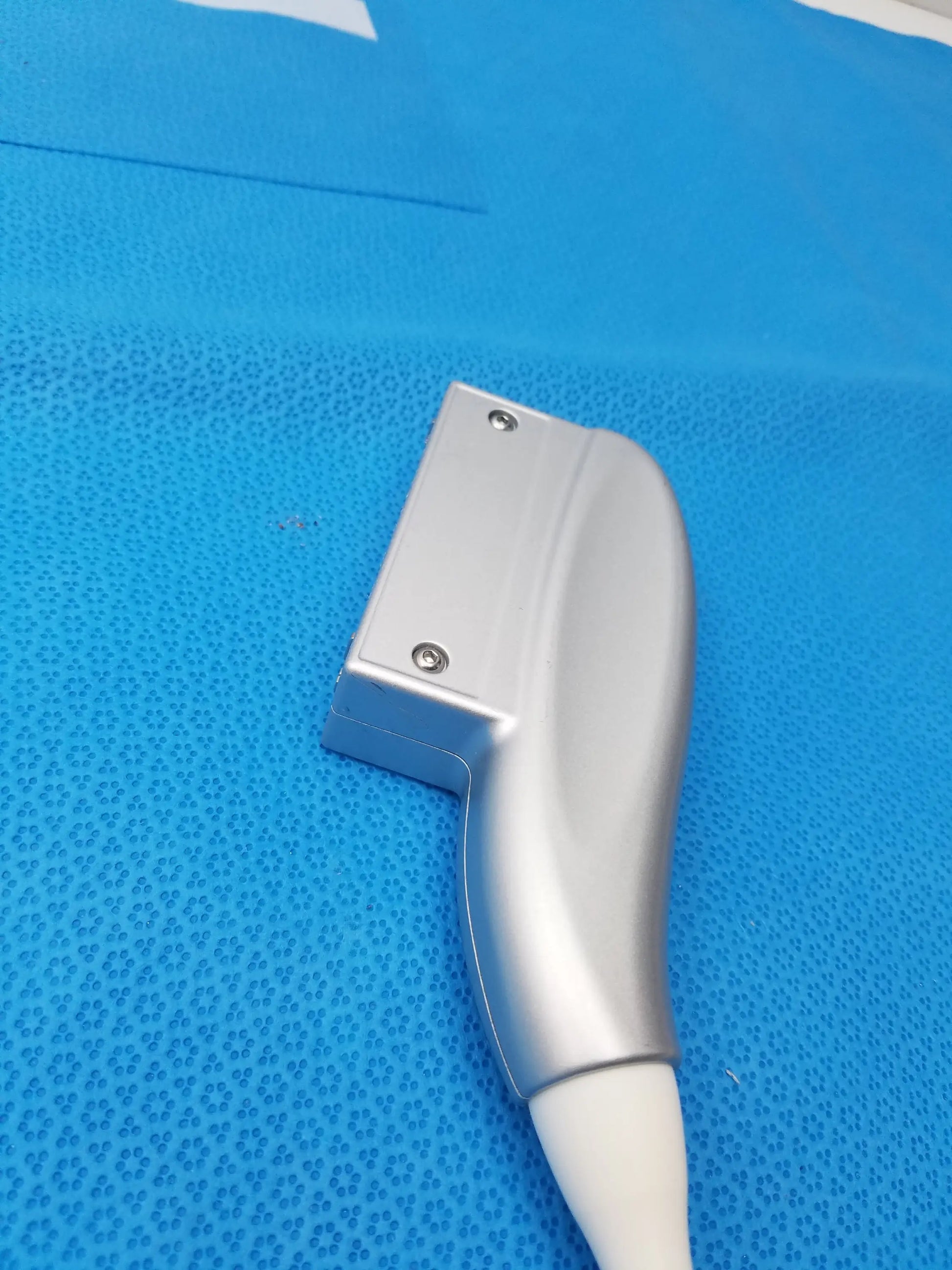 Silver metallic GE Medical Systems 4C-RS convex array ultrasound imaging transducer with smooth curved handle and visible screws