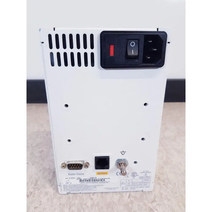 White axys comm power supply unit with black control panel red switch and ports on the back of ge prn 50-m thermal medical digital printer