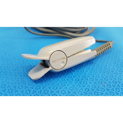 White plastic nelcor hair straightener with textured grip and coiled cord for ge spo2 interface cable use