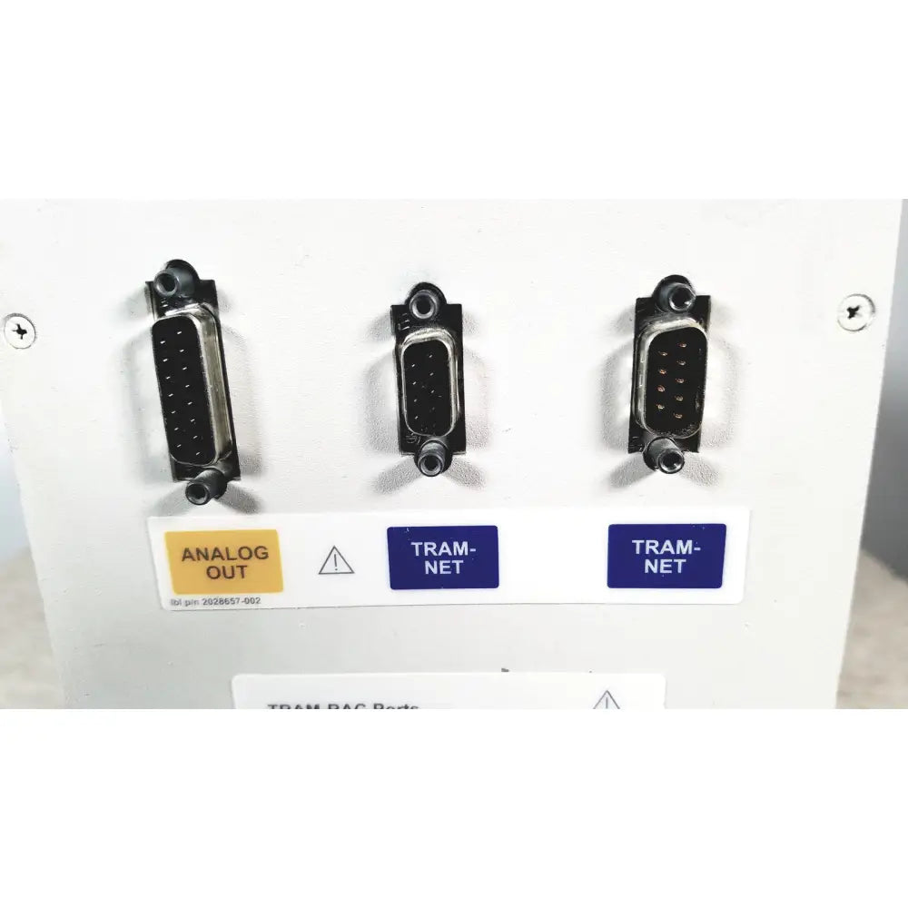 Three black d-sub connectors labeled analog out and tram net on the back of a ge tram-rac 4a module rack panel