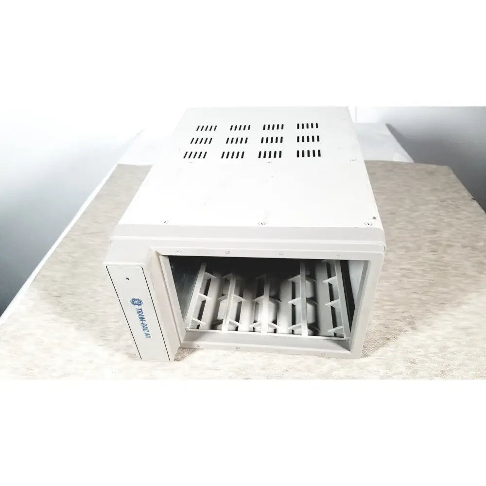 White rectangular hvac vent with slotted grid and metal grilles for cooling in GE TRAM-RAC 4A module rack reuse medical setup