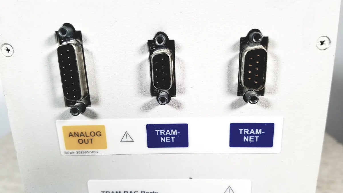 Three black d-sub connectors labeled analog out and tram net on the back of a ge tram-rac 4a module rack panel