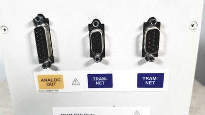 Three black d-sub connectors labeled analog out and tram net on the back of a ge tram-rac 4a module rack panel