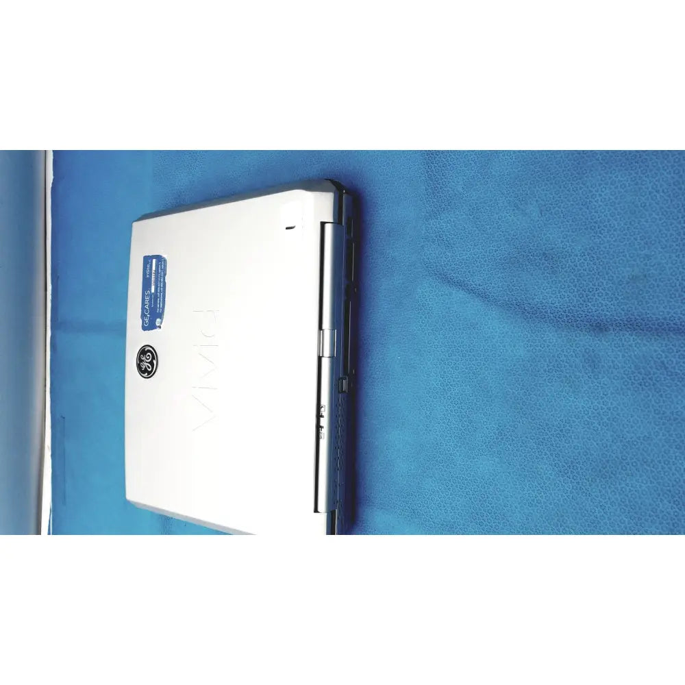 Silver ge vivid portable ultrasound machine with sleek compact design and blue sticker on top left corner