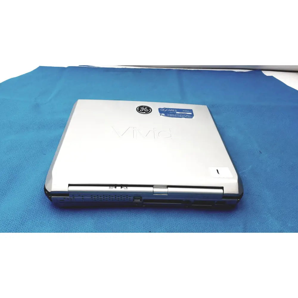 Silver ge vivid portable ultrasound machine with sleek metallic finish and subtle branding on the lid