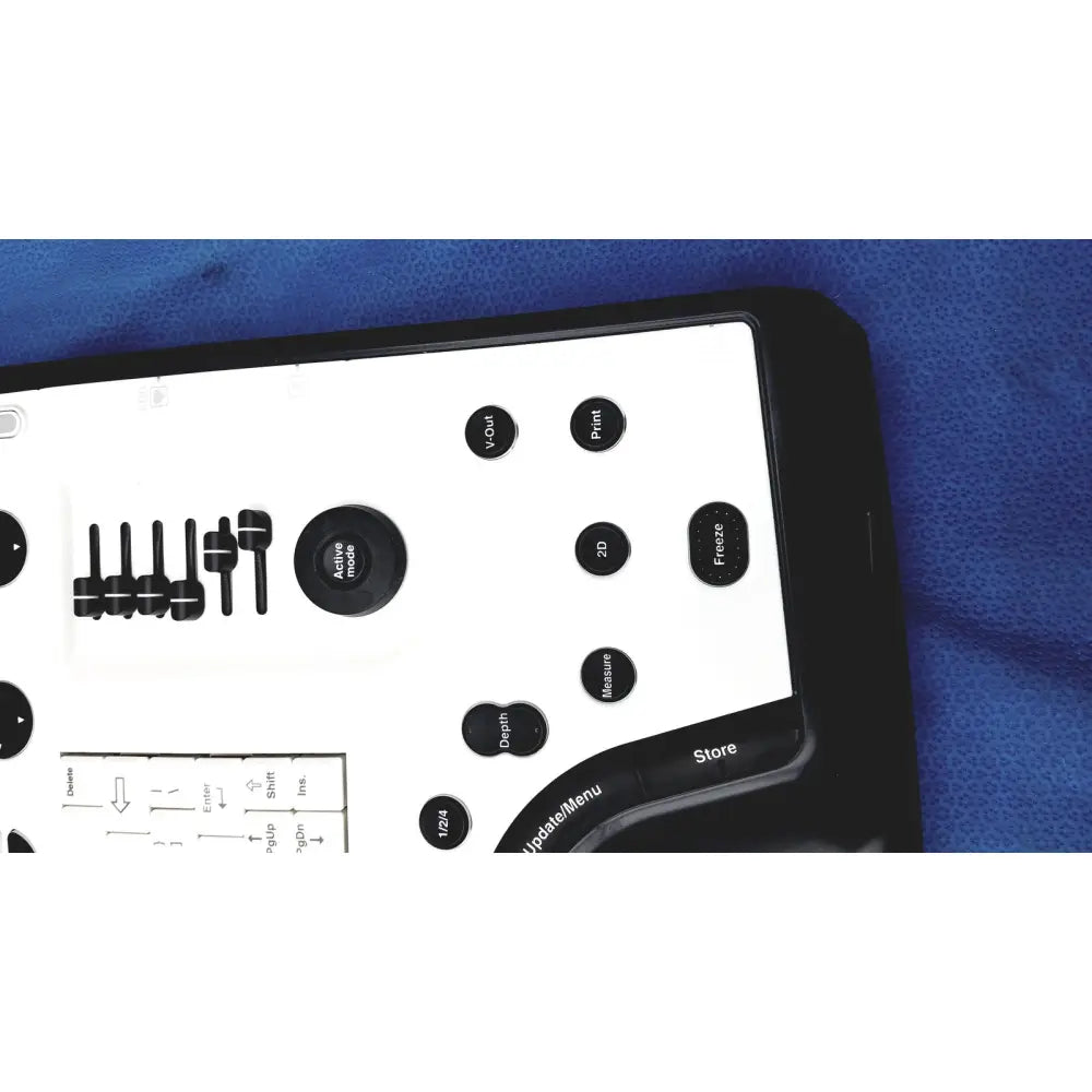 Black and white control panel with circular buttons on the ge vivid portable ultrasound machine for easy operation