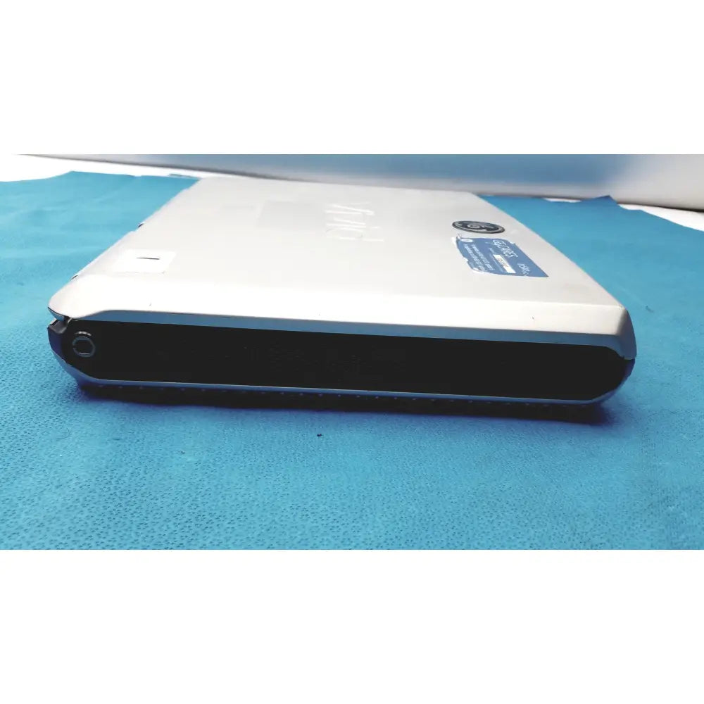 Silver and black sony vaio laptop with matte finish lid shown with vivid portable ultrasound machine product next to it