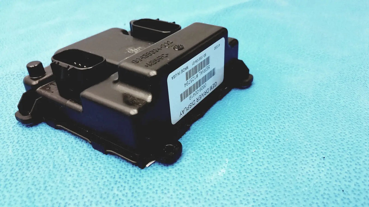 Black plastic gem driver display ecu module with white label barcode and part numbers showing serial number 125794 back side