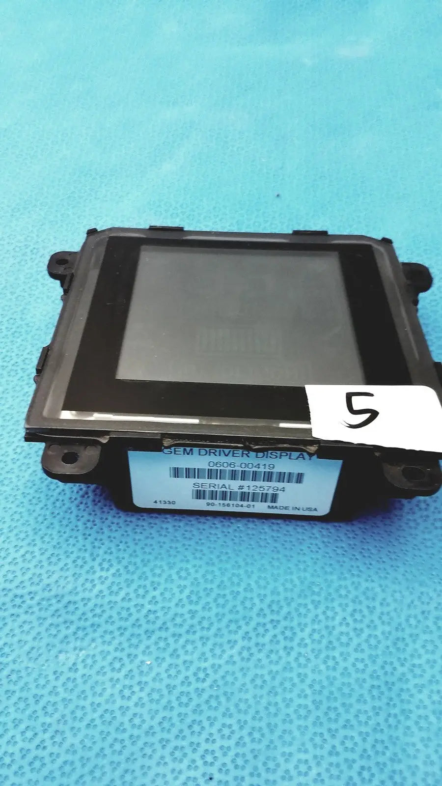 Black plastic gem driver display 0606-00419 with rectangular screen and mounting brackets for vehicle use