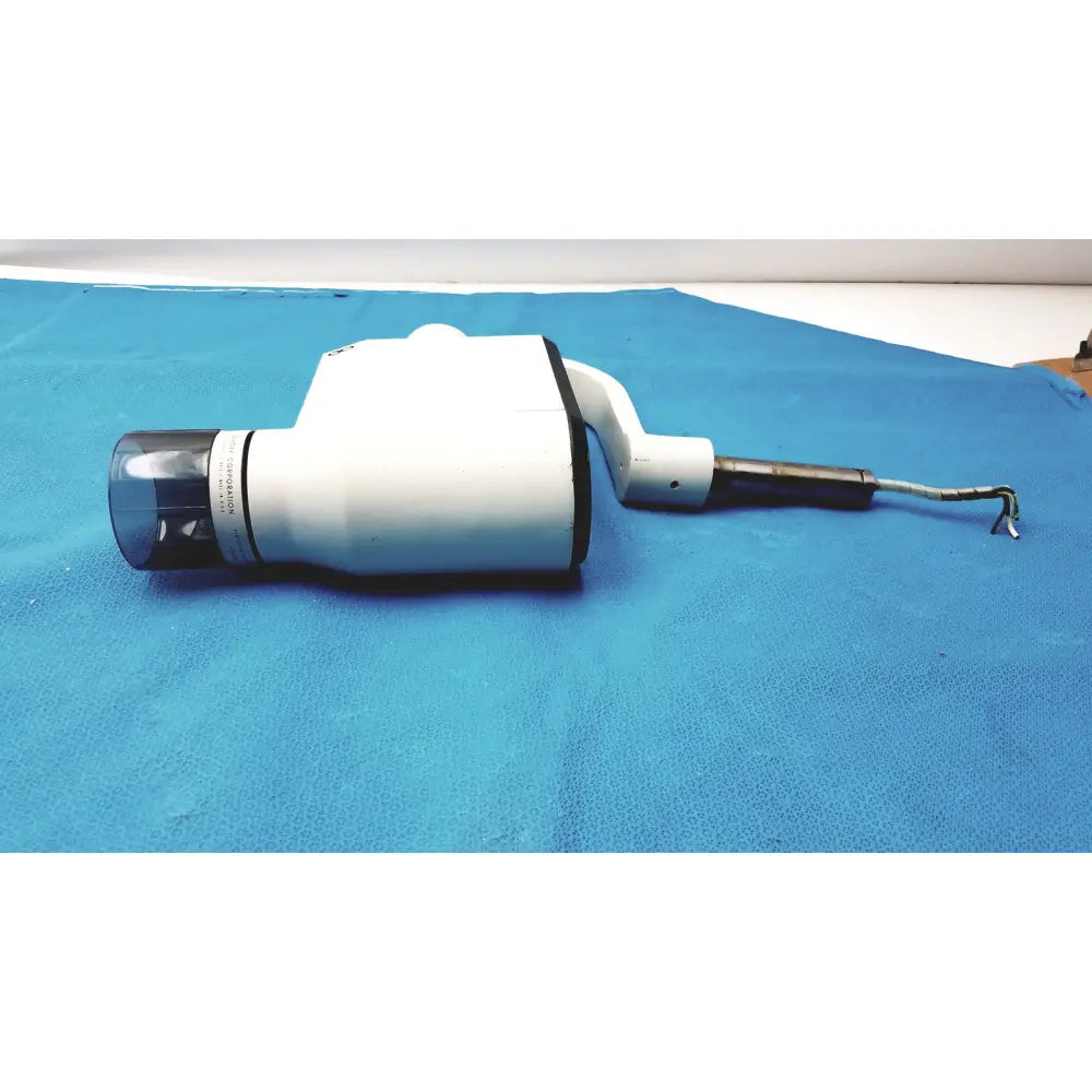 White gendex 770 tube head with clear lens black accents and coiled cable for reuse medical imaging equipment