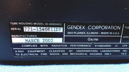 Black plastic label with white text on gendex 770 tube head detailing model and manufacturer for imaging equipment reuse medical