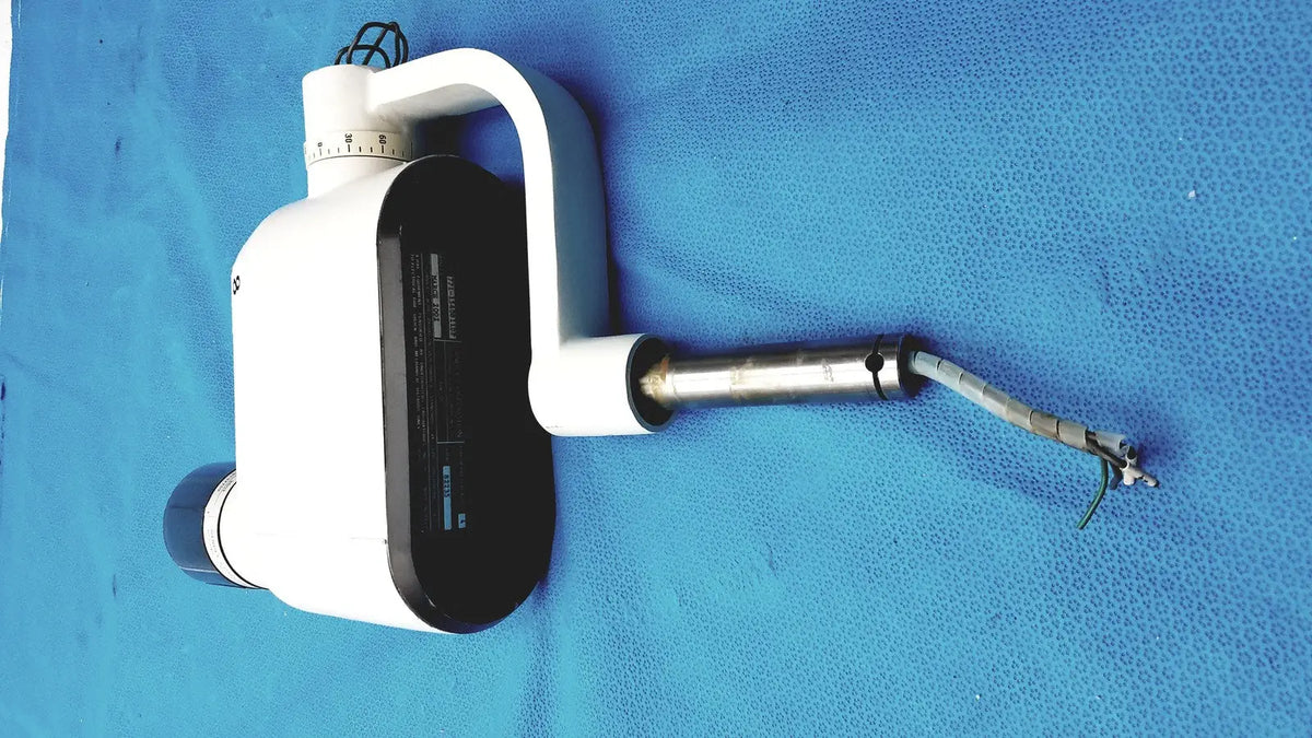 Gendex 770 tube head imaging equipment in white and black with curved handle, adjustable arm, and metallic tip for reuse medical use