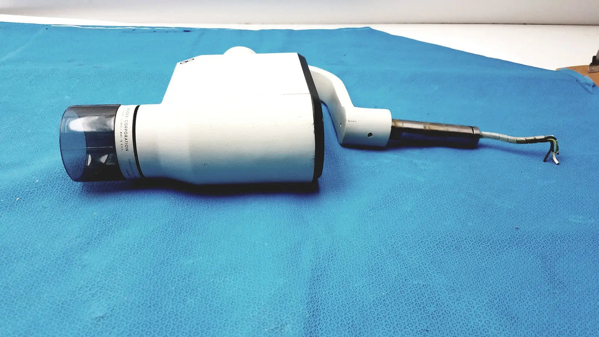 White gendex 770 tube head with clear lens black accents and coiled cable for reuse medical imaging equipment