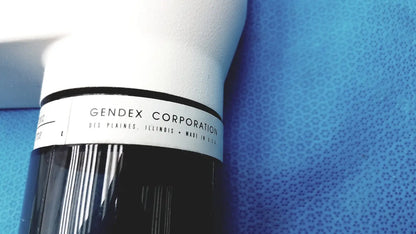White and black cylindrical tube head for imaging equipment by gendex corporation for reuse medical applications