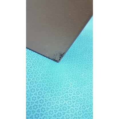 A matte brown general purpose medium steel nema 1 enclosure panel with a textured surface and minor dark specks on the corner