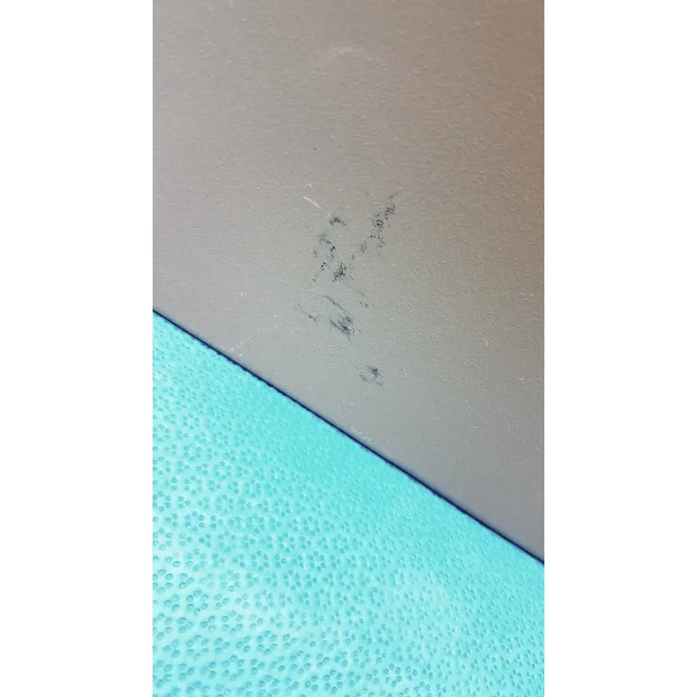 A small cluster of dark textured debris on a beige surface inside a general purpose medium steel nema 1 enclosure