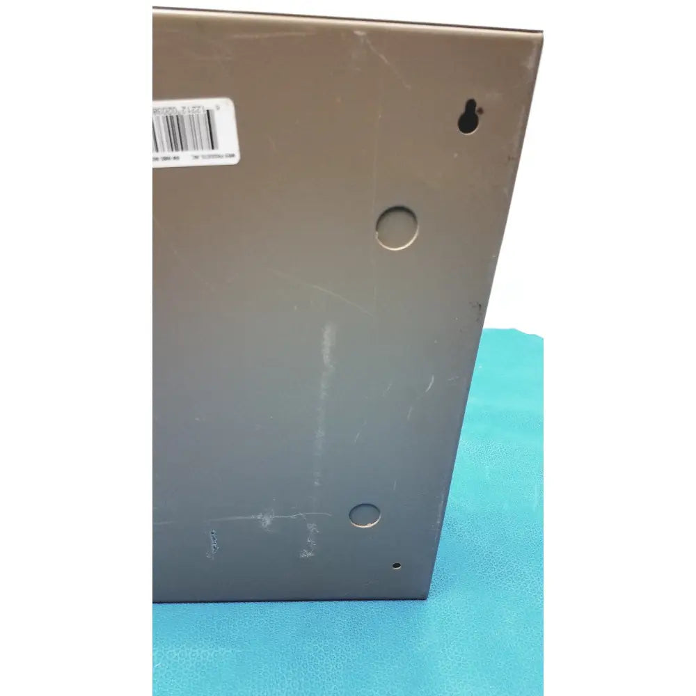 Dark gray general purpose medium steel nema 1 enclosure showing back panel with barcode label and three circular holes