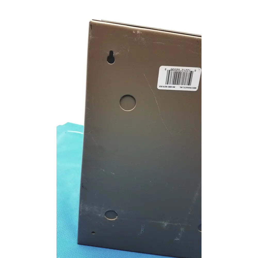 Matte black rectangular general purpose medium steel nema 1 enclosure back plate with three circular holes and barcode sticker