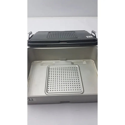 Genesis solid brass sterilization container with black perforated lid and silver metal tray with matching insert