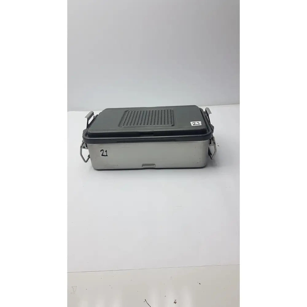 Gray and silver metal genesis solid brass sterilization container with perforated lid and side handles for surgical instruments