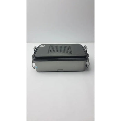 Gray and black two-tone genesis solid brass sterilization container with perforated lid and metal latches for surgical use